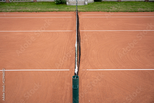 a net dividing the clay tennis court