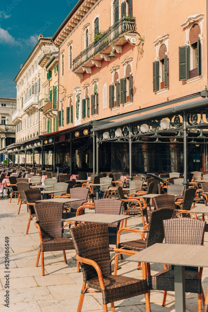 Empty street cafe in Verona old city, Italy. Beautiful sunny morning.