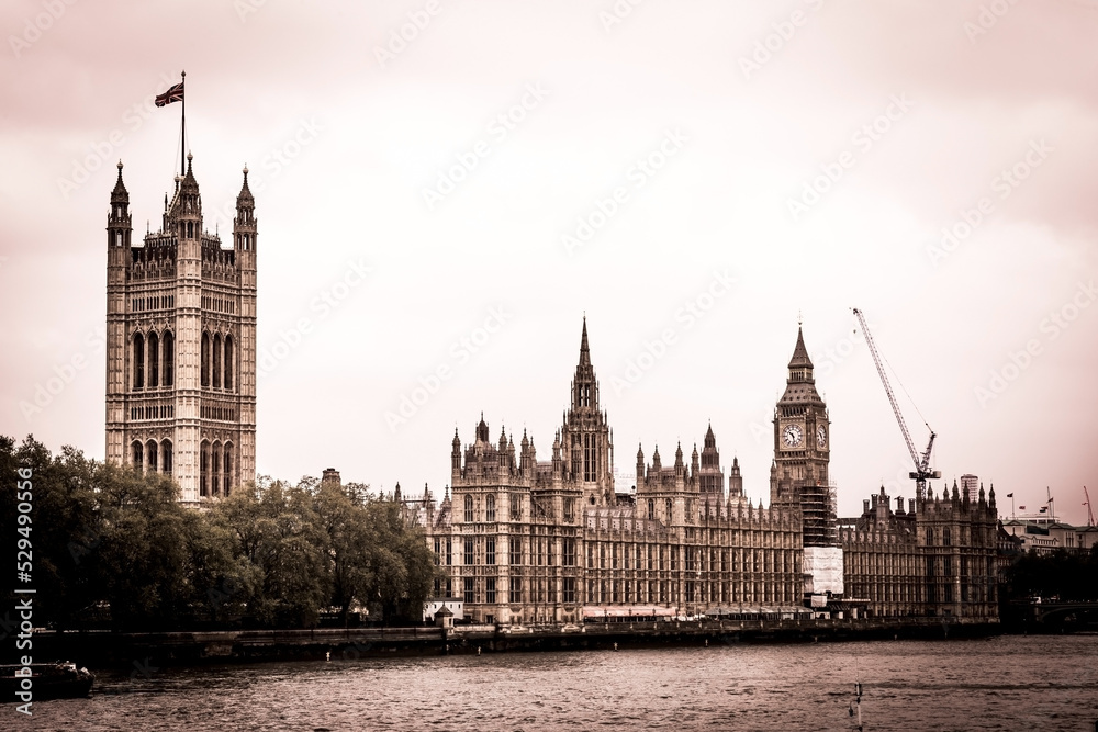Big Ben and Houses of Parliament in dark colors, London, UK.
