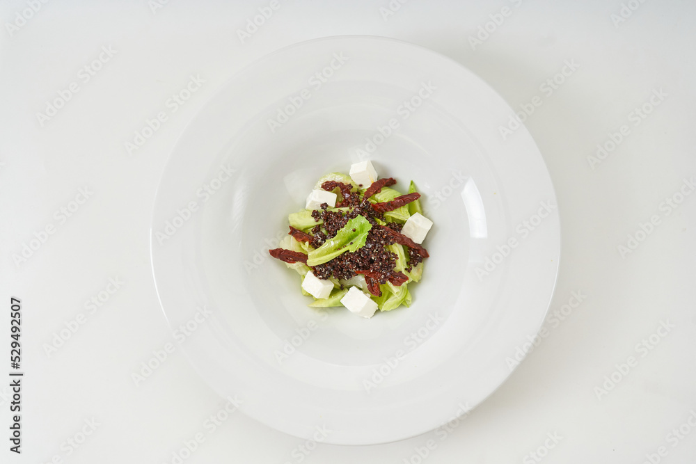 piece of fresh lettuce, sun-dried tomatoes, feto cheese piece of fresh lettuce, sun-dried tomatoes, feto cheese