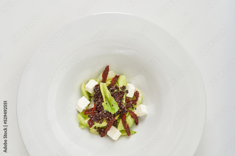 piece of fresh lettuce, sun-dried tomatoes, feto cheese piece of fresh lettuce, sun-dried tomatoes, feto cheese