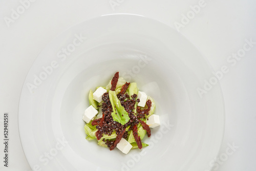 piece of fresh lettuce, sun-dried tomatoes, feto cheese