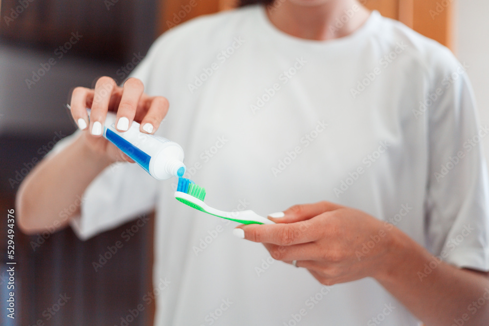 Woman hands holding toothpaste and toothbrush Woman hands holding toothpaste and toothbrush