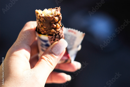 Close up of unrecognizable woman eating protein bar on a break