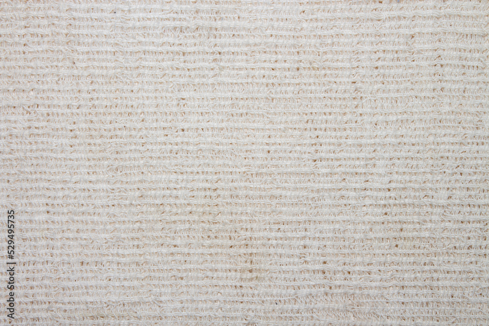 The texture of the canvas fabric.Old rag background. A rag for washing floors.Background of a canvas rag. The texture of the canvas fabric.Old rag background. A rag for washing floors.Background of a canvas rag.