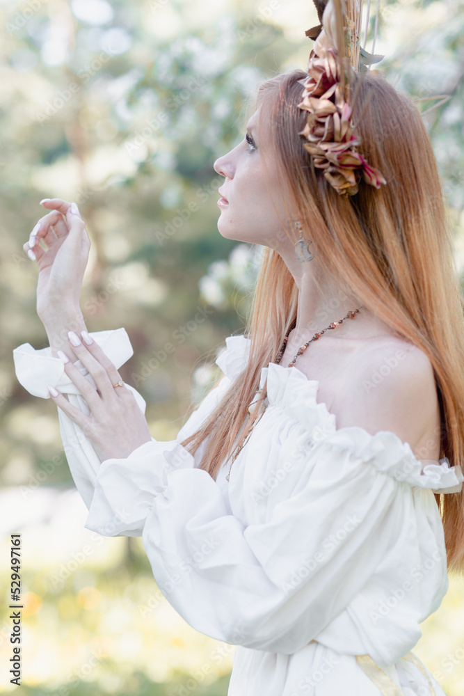 Obraz premium Bride of the sun in white in the apple trees 