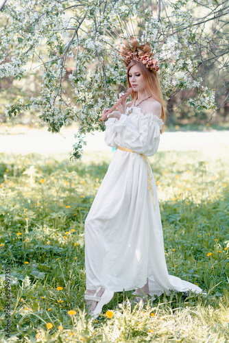 Bride of the sun in white in the apple trees 