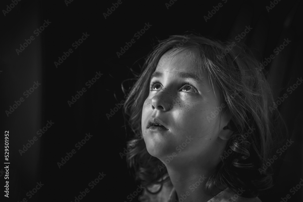 a little girl sits alone in a dark hallway. fear, loneliness