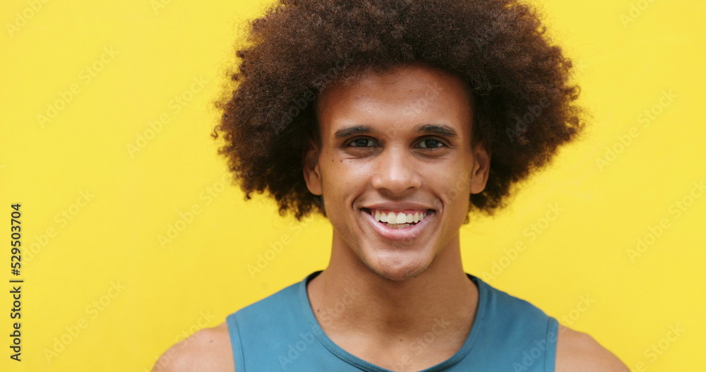 African american Mixed race young man smiling in yellow background