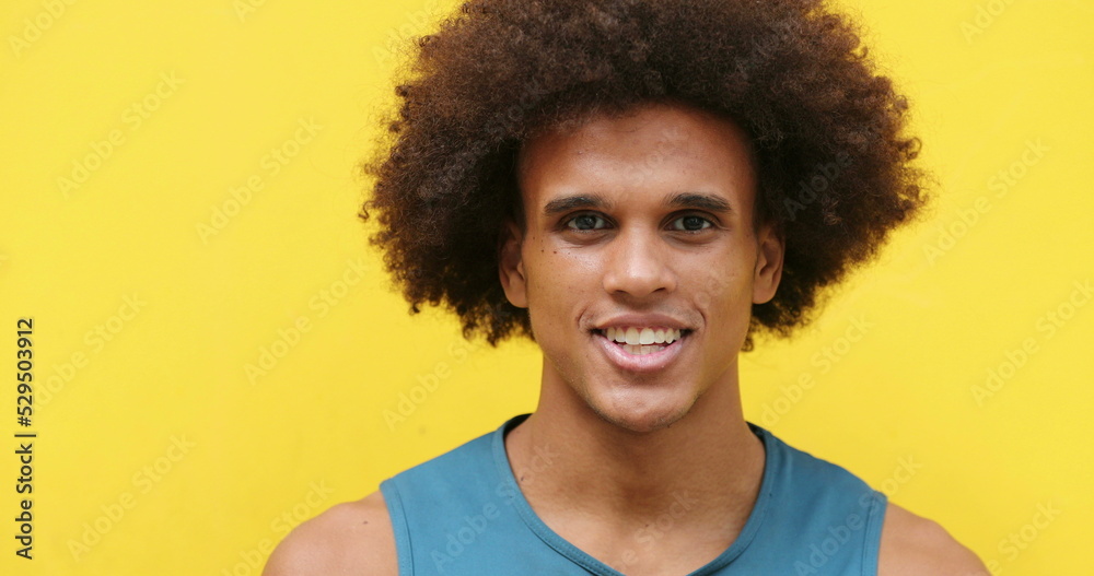 African american Mixed race young man smiling in yellow background