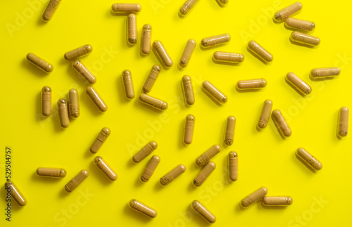 kratom pills random composition on yellow background