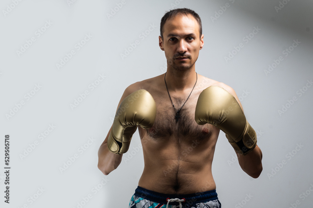 Fototapeta premium The thin man in boxing gloves.