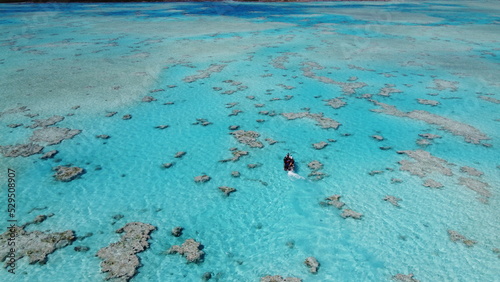 Aerial view of the ocean with a boat, Tuamotus, French Polynesia photo