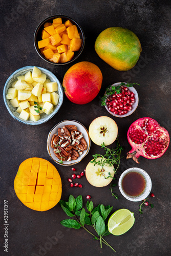 Ingredients for making salad with mango, apple, pomegranate and mint