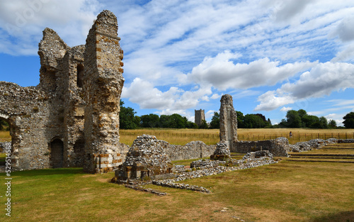 Fotografia Part of Castle Acre priory with Castle Acre village church tower in background