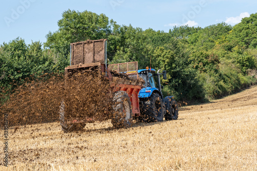 Farmer muck spreading in a field © NosamA