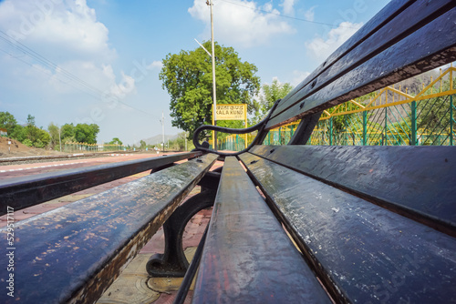 Railway sign board, seating bench at railway station platform of mountain village Kalakund near Mhow, Indore, Madhya Pradesh on a sunny summer day. Indian village. photo