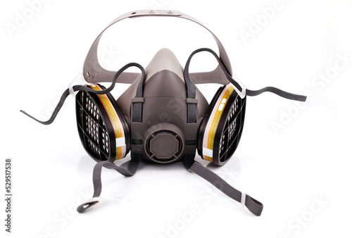 Reusable half-face elastomeric respirator for air purification with replaceable filters on a white background photo