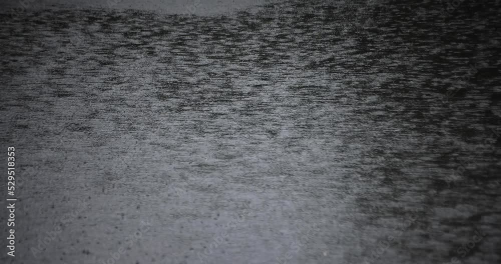 A slow motion of puddle at the pond rainy day