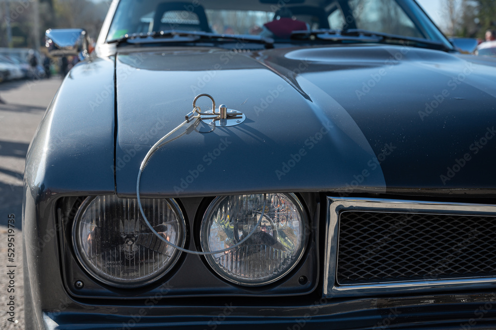 Detail of an old sports car, gray Ford Capri with two black stripes
