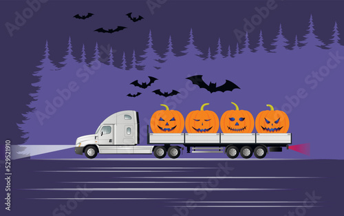 A modern American truck with a semi-trailer carries pumpkins on Halloween at night past a forest with bats.