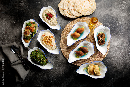 Assorted mix mezza with falafel, pita bread, salad, hummusm, served in a dish side of food set photo