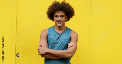 Bipolar Young african american black man changing emotions crossing arms becoming serious and then smiling with arms crossed