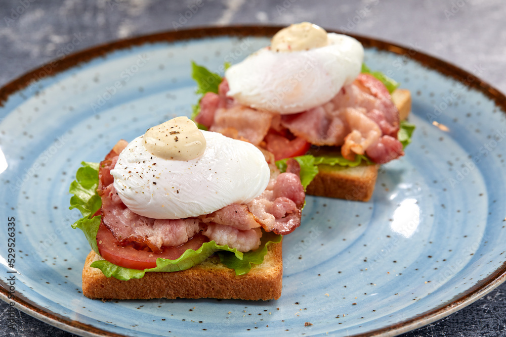 toasts with poached egg and bacon