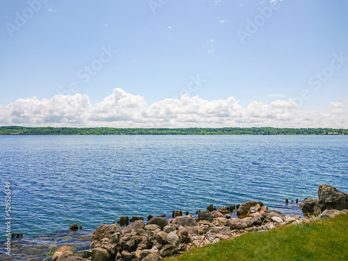 Georgian Bay near Spirit Rock Conservation Area at Wiarton, Ontario, Canada. Landscape of the Huron Lake water and old withered wooden dock posts or marina wreck. photo