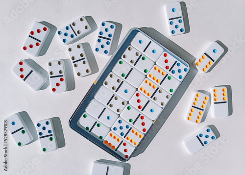 Domino game on a white table. dominoes and a box. Domino effect.