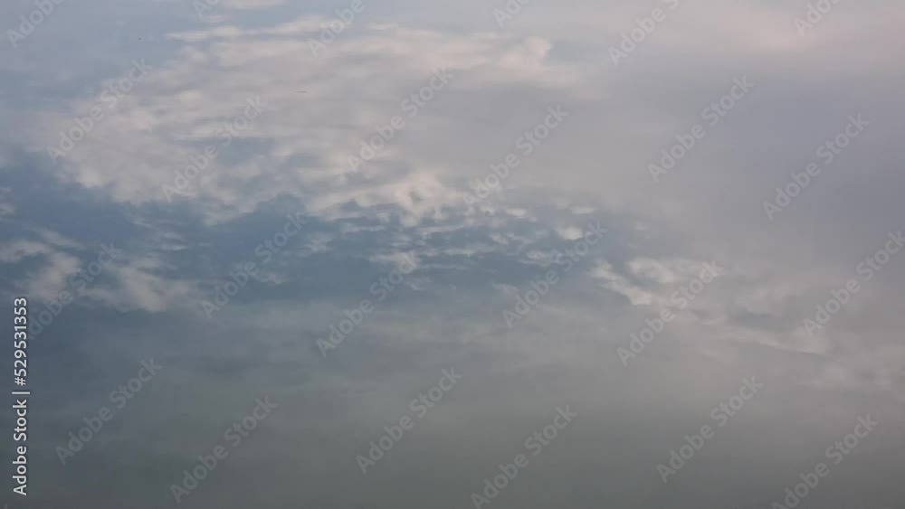 Reflection of the sky with clouds in the river water Reflection of the sky with clouds in the river water