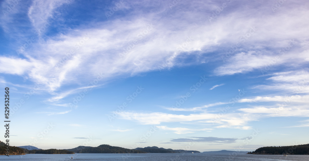 Cloudy Cloudscape during sunny summer Day on the West Coast of Pacific Ocean. British Columbia, Canada. Sunset Sky Cloudy Cloudscape during sunny summer Day on the West Coast of Pacific Ocean. British Columbia, Canada. Sunset Sky