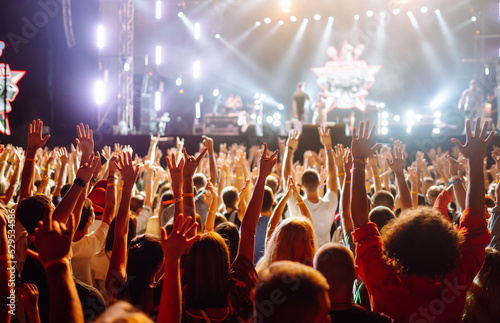 Сrowd with raised hands at music festival. Youth, party, vacation concept.