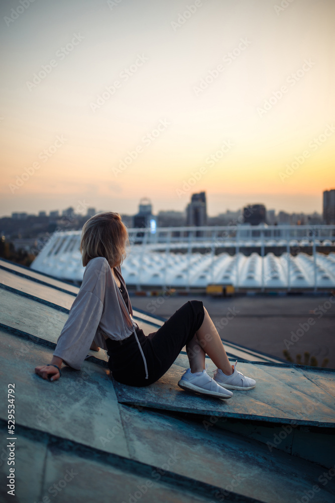 Photo shoot on the roof. Young woman posing in the roof, amazing view of city. People, lifestyle, relaxation concept. Photo shoot on the roof. Young woman posing in the roof, amazing view of city. People, lifestyle, relaxation concept.