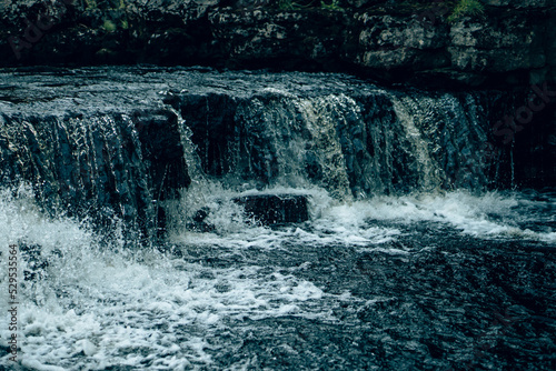 Water and waterfalls at Ingleton in the Yorkshire countryside with a retro film look