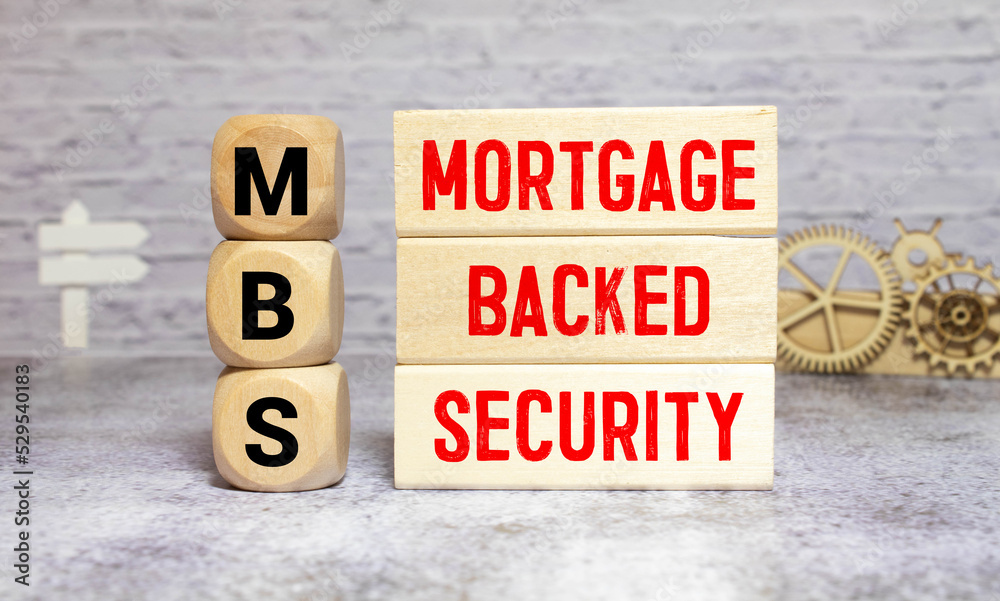 Hand of a business man completing the puzzle with the last missing piece.Concept image of Business Acronym MBS Hand of a business man completing the puzzle with the last missing piece.Concept image of Business Acronym MBS