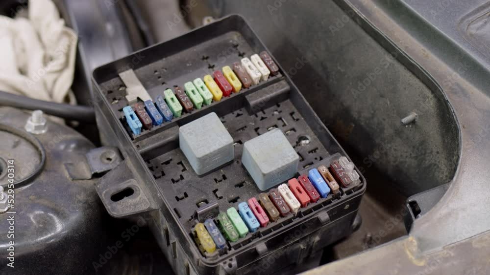 close up view of fuse box under hood of old car in service. Different