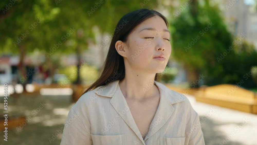 Chinese woman smiling confident standing at park