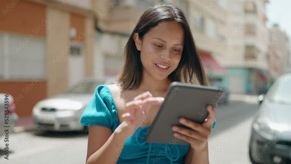 Young hispanic woman smiling confident using touchpad at street Young hispanic woman smiling confident using touchpad at street