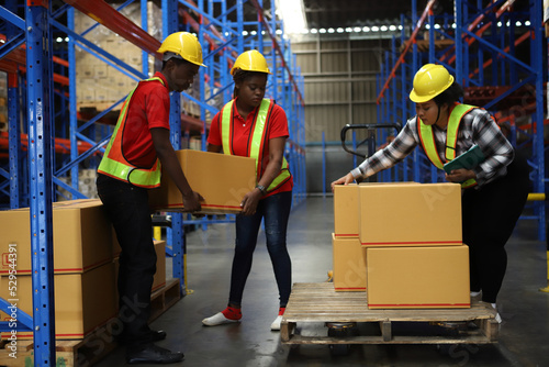  Portrait of worker in warehouse, they happy and working at The Warehouse. Storehouse area, Shipment. warehouse worker unloading pallet goods in warehouse