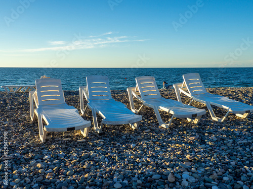 Beach beds. Folded beds. End of the season. On the Sunset. Beach vacation. © Aleksandr