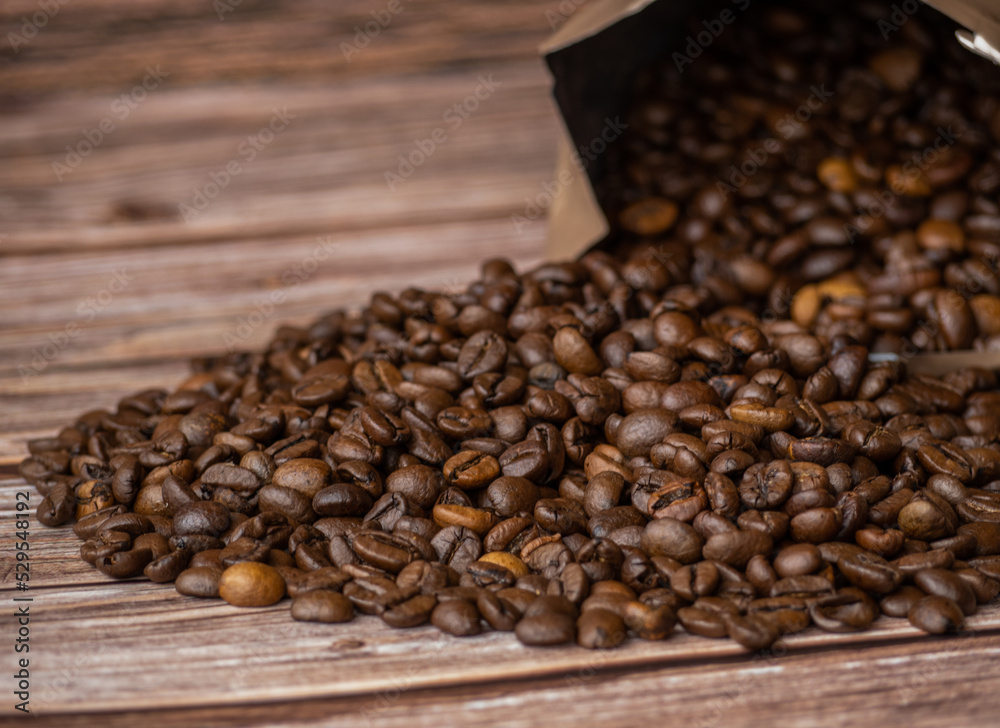 Fototapeta premium Coffee beans on wood background