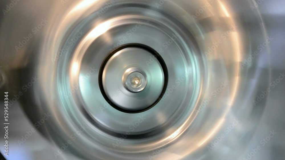 rotated silver industrial metal ring closeup with vibrance effect, permanent motor vibration, industry oscillation, flutter diversity
