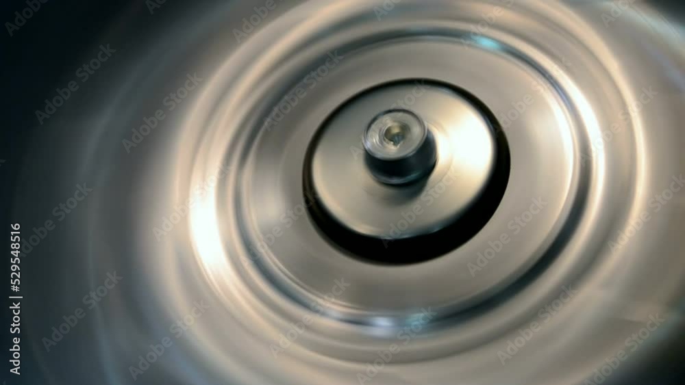 rotated silver industrial metal ring closeup with vibrance effect, permanent motor vibration, industry oscillation, flutter diversity