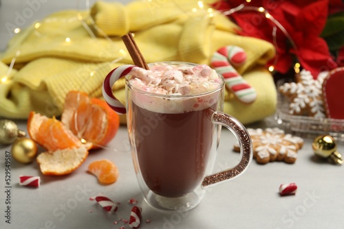 Composition with delicious marshmallow drink, festive items and yellow sweater on light table