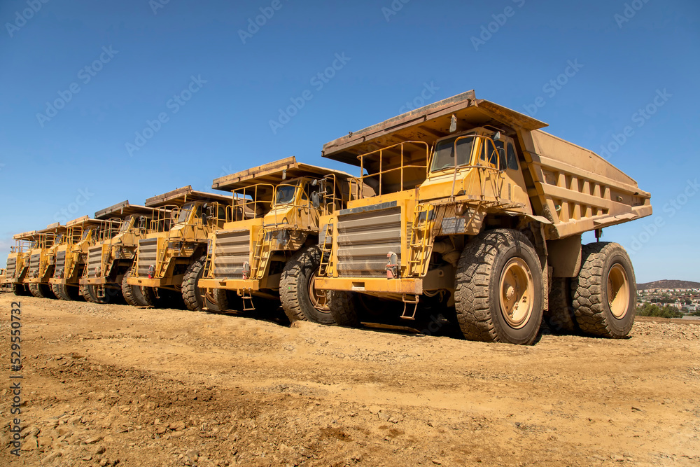 Large dump trucks in a row at a construction site 007
