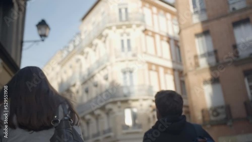 two friends walking in a street of an authentic city in Toulouse, France