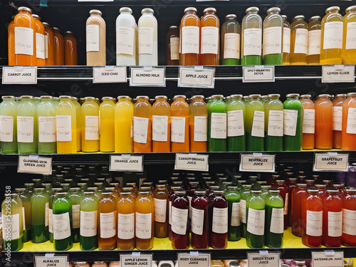 Canvastavla Bottles with healthy juices in the organic grocery store