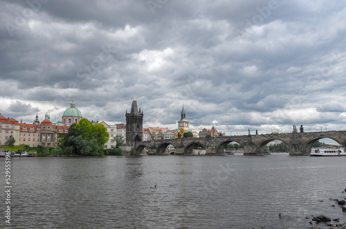 Scenic view of of the Vltava river, Charles Bridge and Old Town Bridge Tower in Prague photo