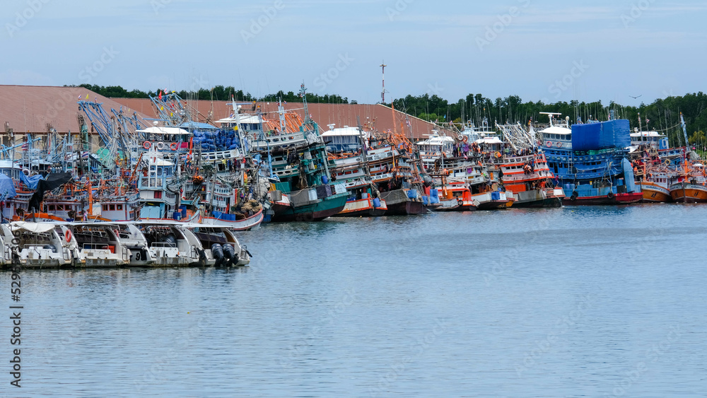 Fishing boats and shrimp boats in Laem Hin Pier, Phuket, Thailand. Fishing boats moored in the port.